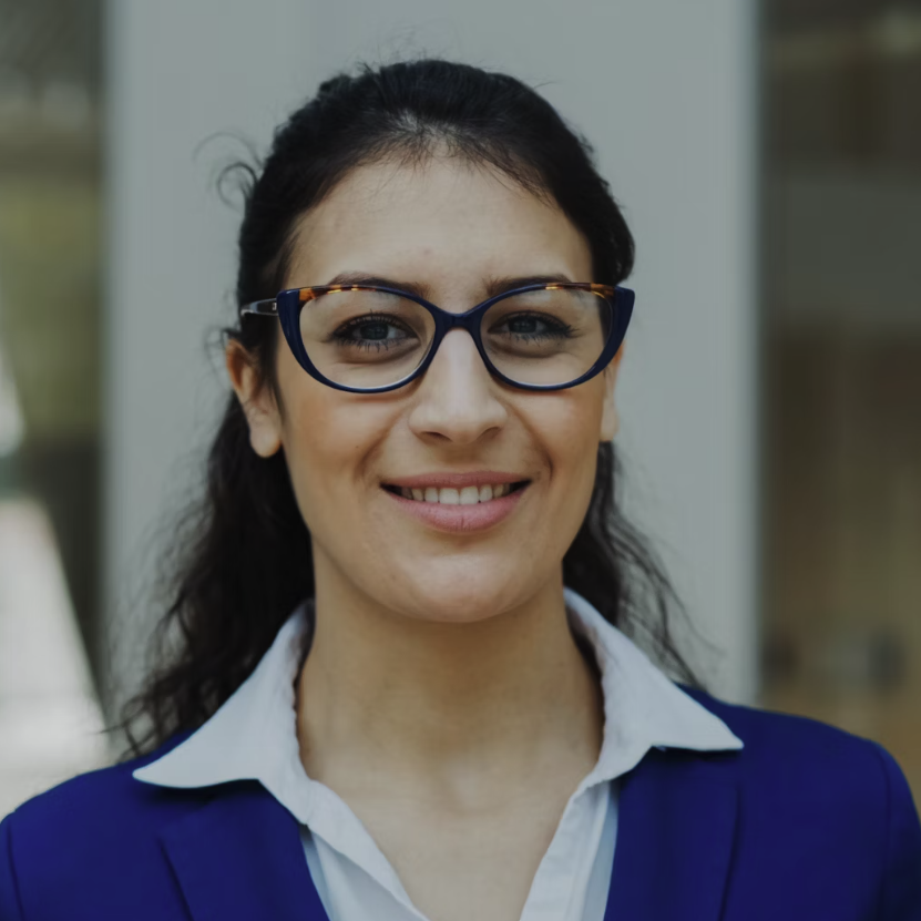 Photo by <a href='https://unsplash.com/@silverkblack?utm_source=unsplash&utm_medium=referral&utm_content=creditCopyText'>Vitaly Gariev</a> on <a href='https://unsplash.com/photos/a-smiling-woman-wearing-glasses-and-a-blue-suit-jI4HREHtae4?utm_source=unsplash&utm_medium=referral&utm_content=creditCopyText'>Unsplash</a>